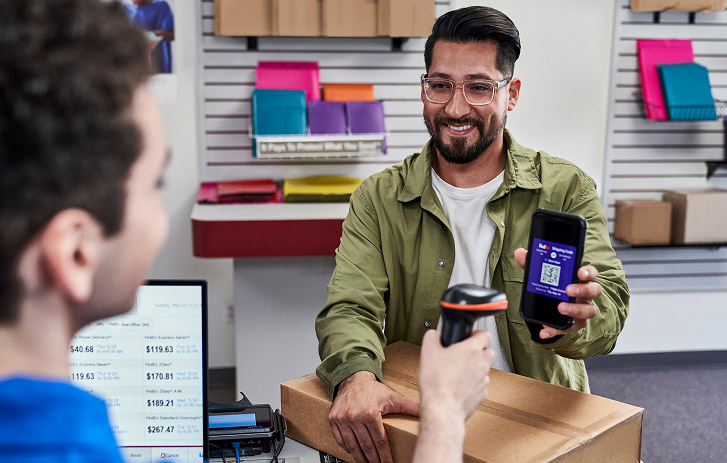 Customer dropping off a package at a retail counter
